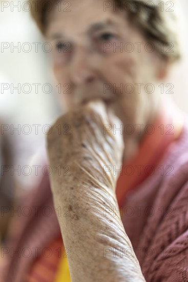 Close-up, authentic, unposed portrait of a 90+ year old senior woman with dementia and Alzheimer's