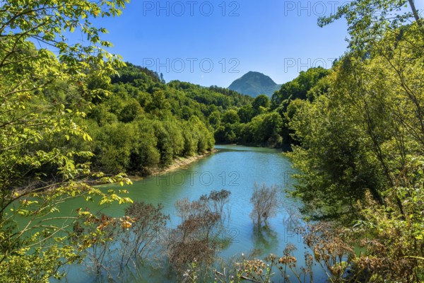 Ibiur reservoir in tolosa, gipuzkoa, basque country, showcases calm waters reflecting lush green