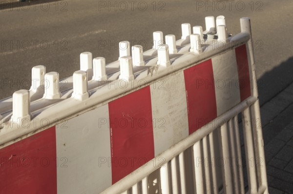 Borken, NRW, Germany, Red and white striped traffic barrier standing on a city street, ensuring