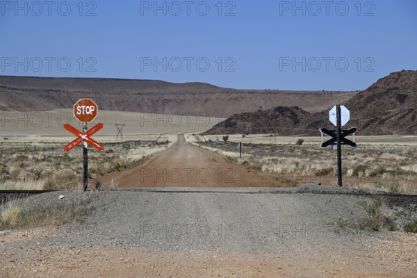 Stop signs at an ungated level crossing on the Lüderitz-Keetmanshoop railway line, near Goageb,
