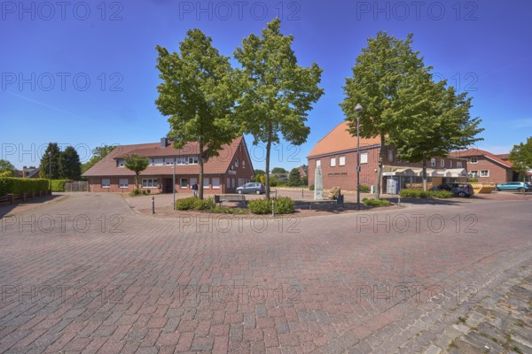 Street, bollards, trees, bench, 1000 year fountain, lantern, clinker brick pavement, concrete