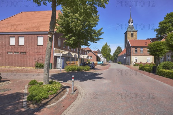 Street, general development, clinker brick building, pointed roof with red roof tiles, church tower