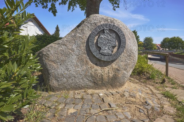 Monument, political event, reunification, flower bed, shrub, trees, cobblestone path, blue sky,