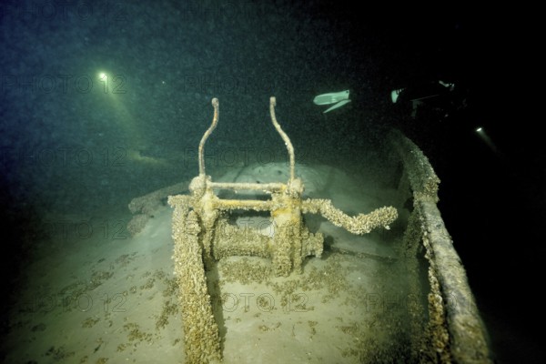 Gloomy shipwreck in Lake Constance, illuminated by rays of light and overgrown with quagga triangle