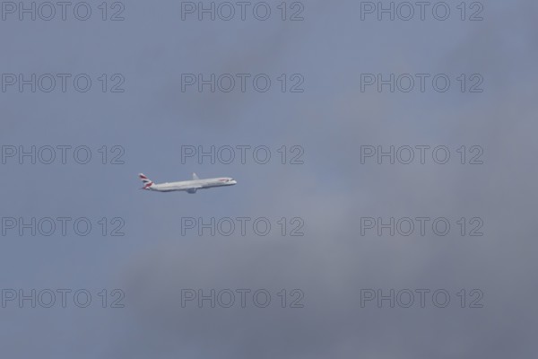 Boeing 787-9 Dreamliner jet passenger aircraft of British Airways airlines in flight in a blue sky,