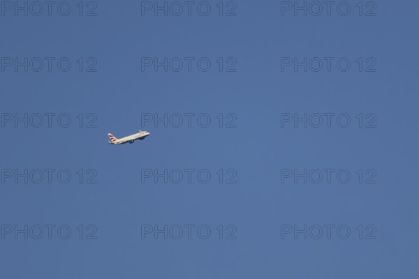 Airbus A320-232 jet passenger aircraft of British Airways airlines in flight in a blue sky, London,