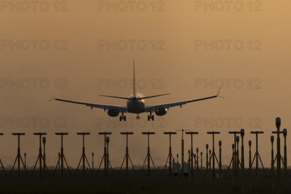 Boeing 737 jet aircraft of Ryanair airlines in flight landing at sunset at London Stansted airport,