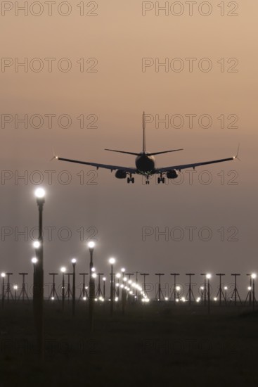 Boeing 737 jet aircraft of Ryanair airlines in flight landing at sunset at London Stansted airport,