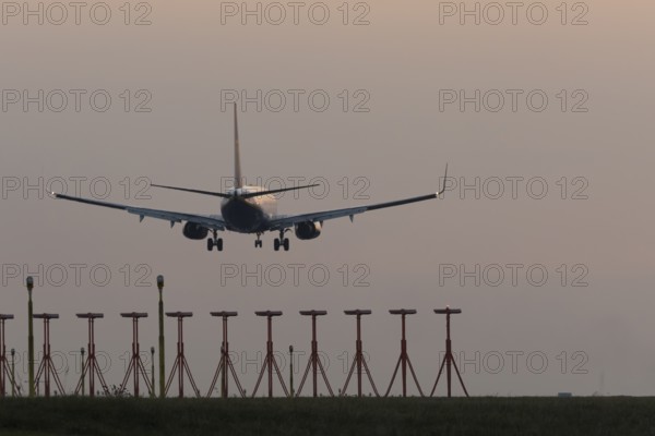 Boeing 737 jet aircraft of Ryanair airlines in flight landing at sunset at London Stansted airport,