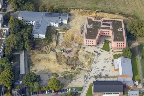Aerial view, Pink building of the Reinoldi comprehensive school and construction site in the