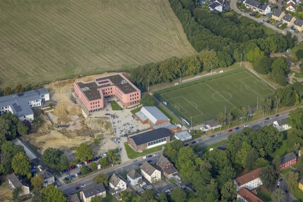 Aerial view, Pink building of the Reinoldi comprehensive school and construction site in the