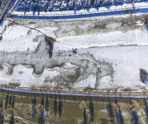 Aerial view, ice rink, ice skaters and pedestrians on frozen Rhine meadow in Lörrick near the