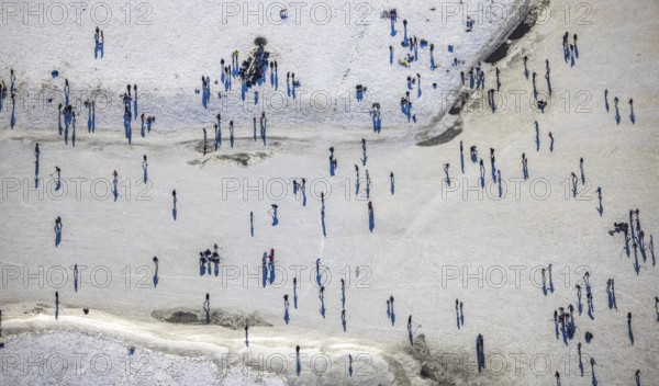 Aerial view, ice rink, ice skaters and pedestrians on frozen Rhine meadow in Lörrick near the