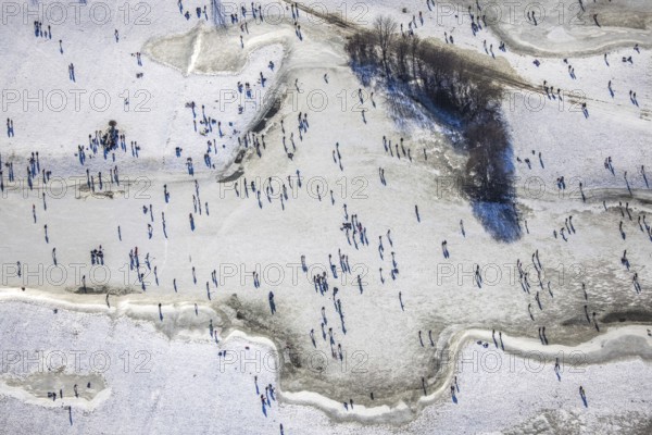 Aerial view, ice rink, ice skaters and pedestrians on frozen Rhine meadow in Lörrick near the