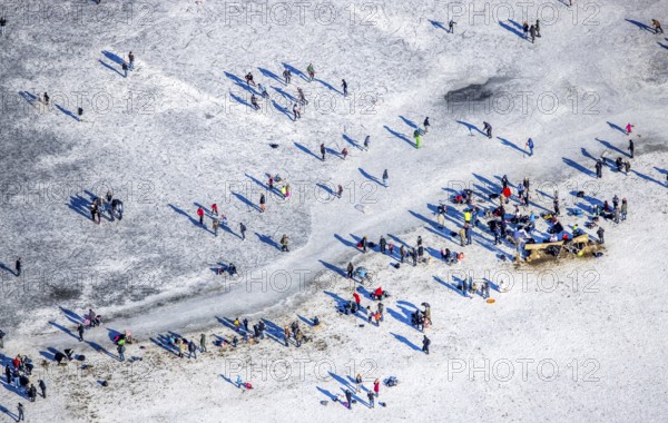 Aerial view, ice rink, ice skaters and pedestrians on frozen Rhine meadow in Lörrick near the