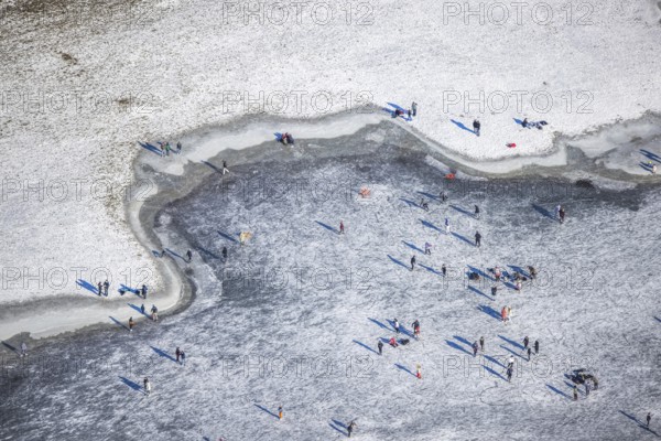 Aerial view, ice rink, ice skaters and pedestrians on frozen Rhine meadow in Lörrick near the