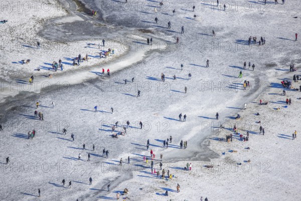 Aerial view, ice rink, ice skaters and pedestrians on frozen Rhine meadow in Lörrick near the