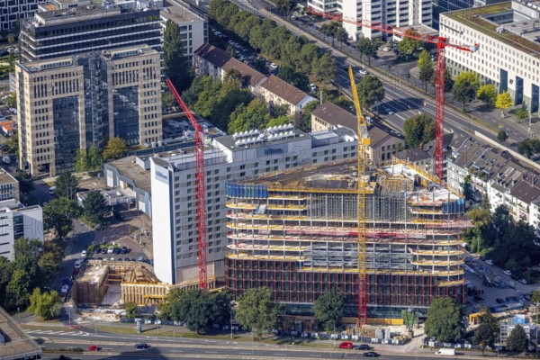 Aerial view, construction site and new construction triangular office tower Eclipse next to the
