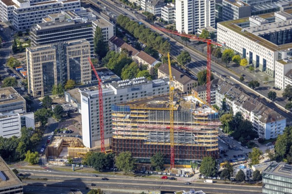 Aerial view, construction site and new construction triangular office tower Eclipse next to the