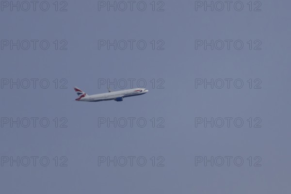 Boeing 787-9 Dreamliner jet passenger aircraft of British Airways airlines in flight in a blue sky,