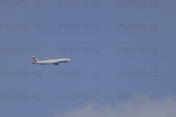 Boeing 787-9 Dreamliner jet passenger aircraft of British Airways airlines in flight in a blue sky,