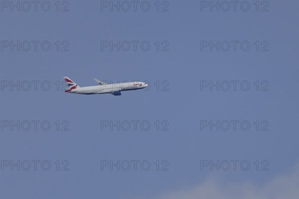 Boeing 787-9 Dreamliner jet passenger aircraft of British Airways airlines in flight in a blue sky,
