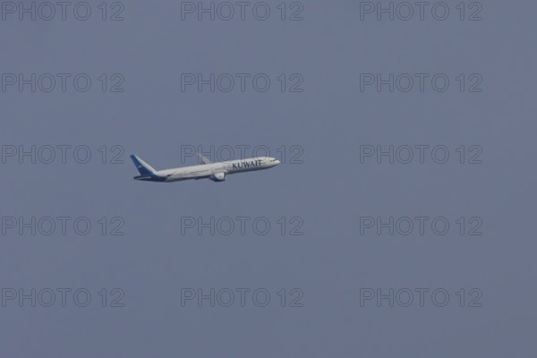 Boeing 777 jet passenger aircraft of Kuwait airlines in flight in a blue sky, England, United