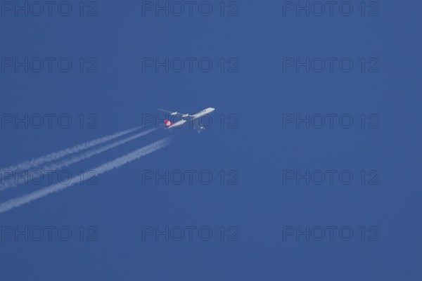 Boeing 747 Jumbo jet cargo aircraft of Cargolux airlines in flight in a blue sky with vapour trails