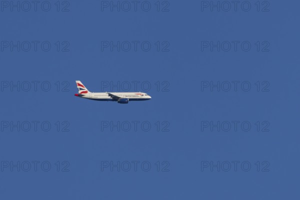 Airbus A320-232 jet passenger aircraft of British Airways airlines in flight in a blue sky, London,