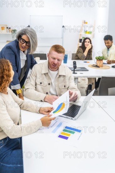 Business professionals collaborating and discussing marketing data with charts and graphs on