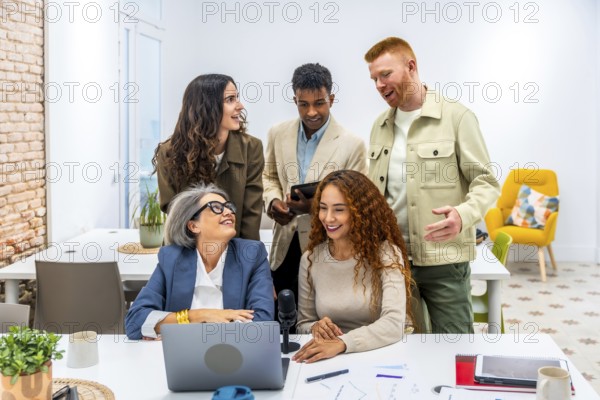 Diverse business team collaborating and brainstorming ideas during a casual work meeting in a