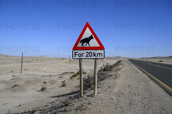 Sign warning of brown hyenas or beach wolves (Parahyaena brunnea), near Lüderitz, Karas Region,