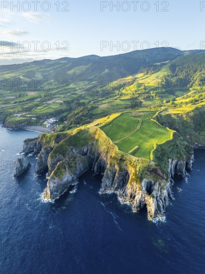 Cape Furado, Rocky Cliffs, Hills, Green Lush Fields, Pasturelands and Atlantic Ocean at Sunrise.