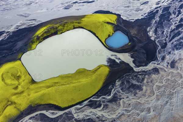 Turquoise-coloured crater lake with moss-covered crater rims in the Icelandic highlands, surrounded