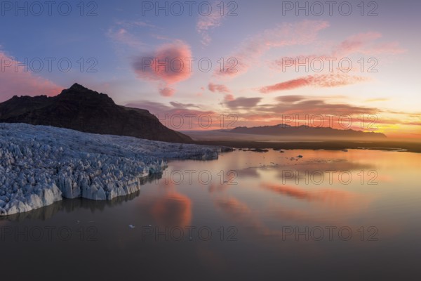 Glacier with Fjallsarlon glacier lagoon at sunrise, Vatnajökull National Park, South Iceland,