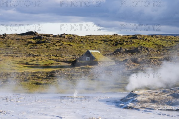 Steaming springs and traditional house at the Hveravellir geothermal area, Icelandic Highlands,