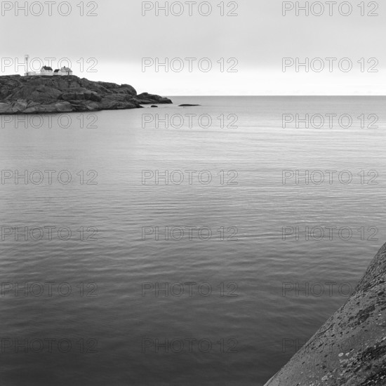 North Sea, Skagerrak, behind a rock with lonely white houses, black and white, analogue, Bohuslän,