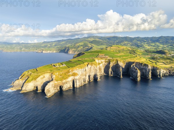 Cape Cintrao, Cliffs, Green Lush Hills, Fields, Pasturelands and Atlantic Ocean on Sunny Evening.
