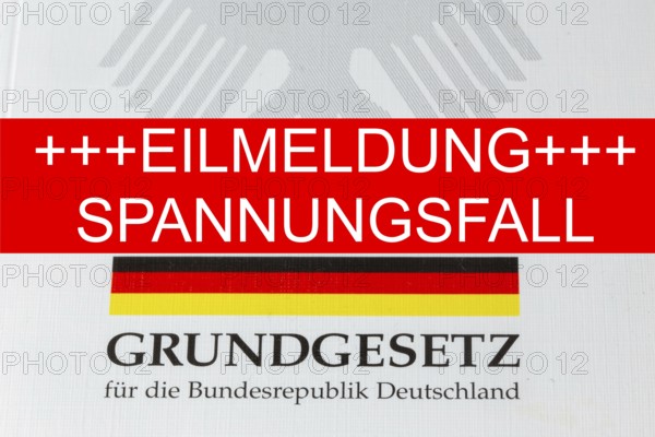 Tension case Symbolic image: The lettering EILMELDUNG SPANNUNGSFALL, with the German Basic Law