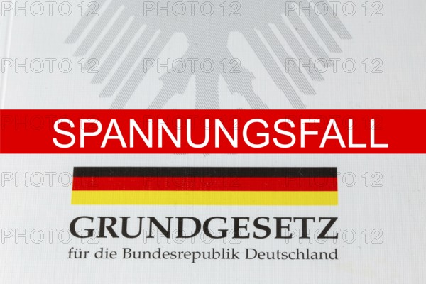 Tension case Symbolic image: SPANNUNGSFALL lettering, with the German Basic Law behind it