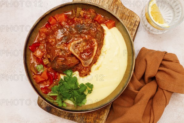 Ossobuco, stewed meat knuckle on the bone, with mashed potatoes, and oats and spices, homemade, no