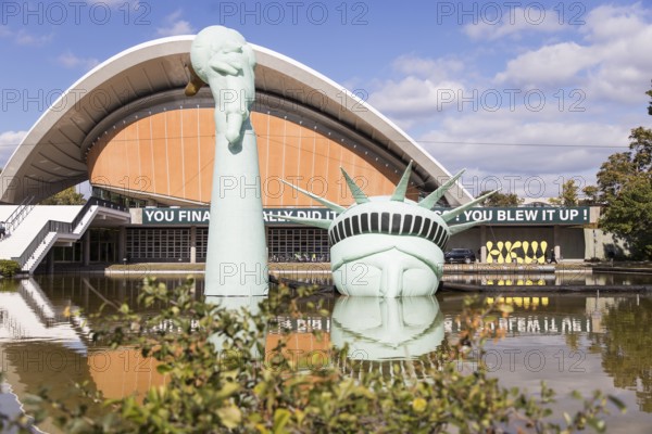 Symbolisation of a Statue of Liberty submerged in water in front of the Haus der Kulturen der Welt