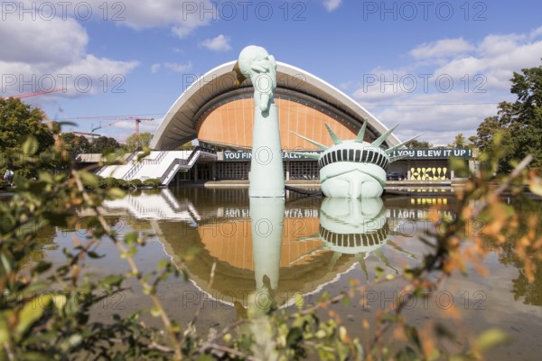 Symbolisation of a Statue of Liberty submerged in water in front of the Haus der Kulturen der Welt