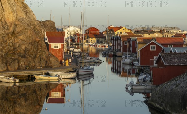 Colourful boathouses and boats in the harbour of Smögen, evening mood, Smögenbryggan, Västra