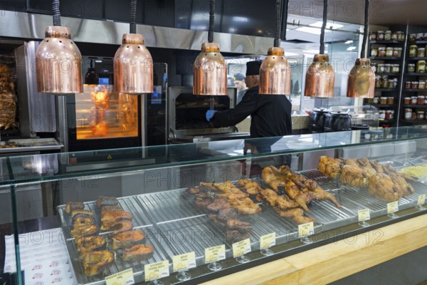 Various meats are prepared on the grill under copper lamps, Gntunik supermarket, Aragazotn