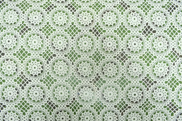 White floral fabric crocheted from cotton threads, textured background