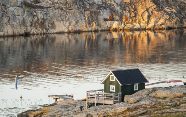 Small green boathouse, evening mood at sunset, Smögen, Smögenbryggan, Västra Götalands Län,