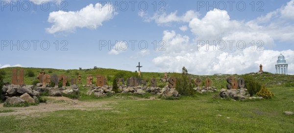 Panoramic view of a landscape with stone pillars and peaceful surroundings under a blue sky,