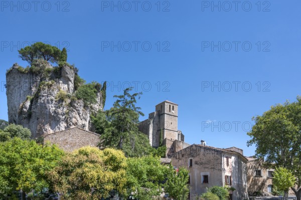 The Romanesque church of Sainte-Marie with its massive bell tower stands embedded in the green of
