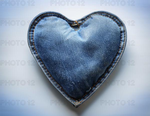 A beautiful heart-shaped denim pillow, symbolizing love and creativity, designed from repurposed